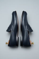 Midnight blue leather loafers with textured finish, perfect for business casual wear.